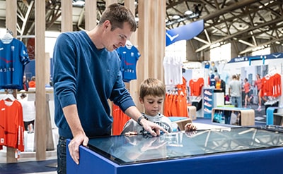 people using touchscreen at HOKA event stand